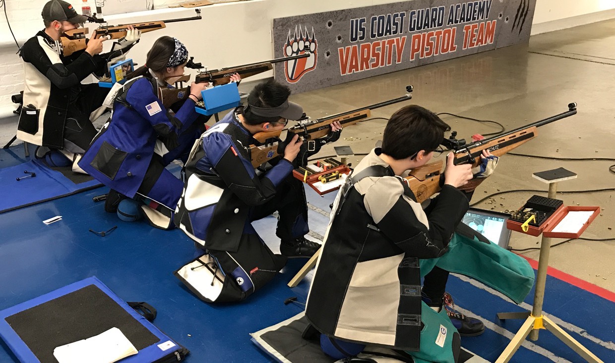 Five athletes of the rifle club prepare to compete in postal match.